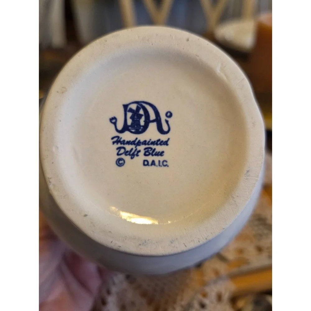 This is a vintage Delft Blue hand-painted ceramic creamer pitcher And Bowl/plate